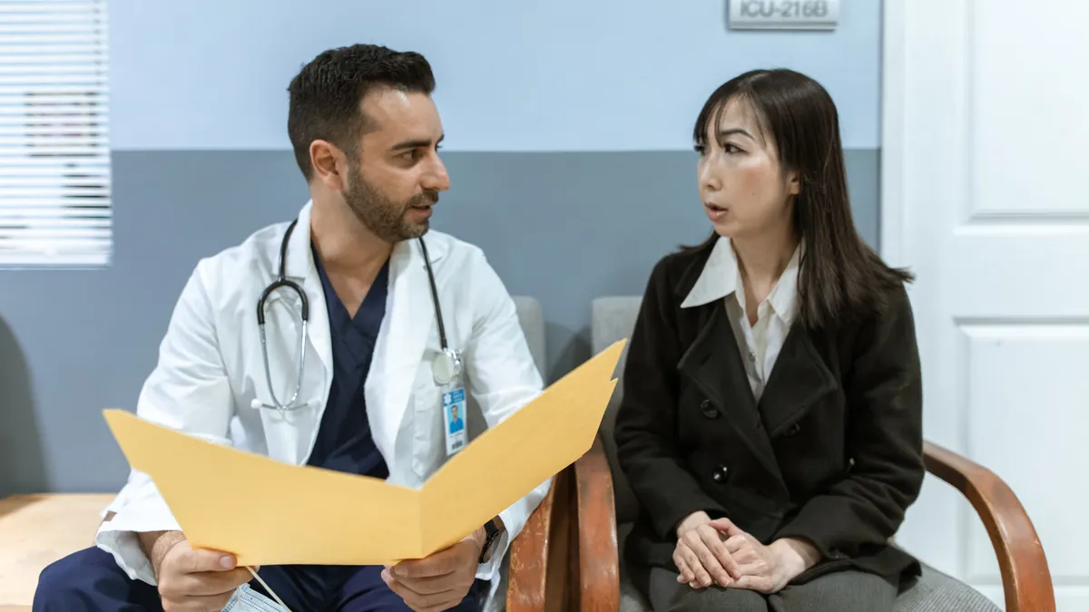 Doctor and patient in a consultation room with folder