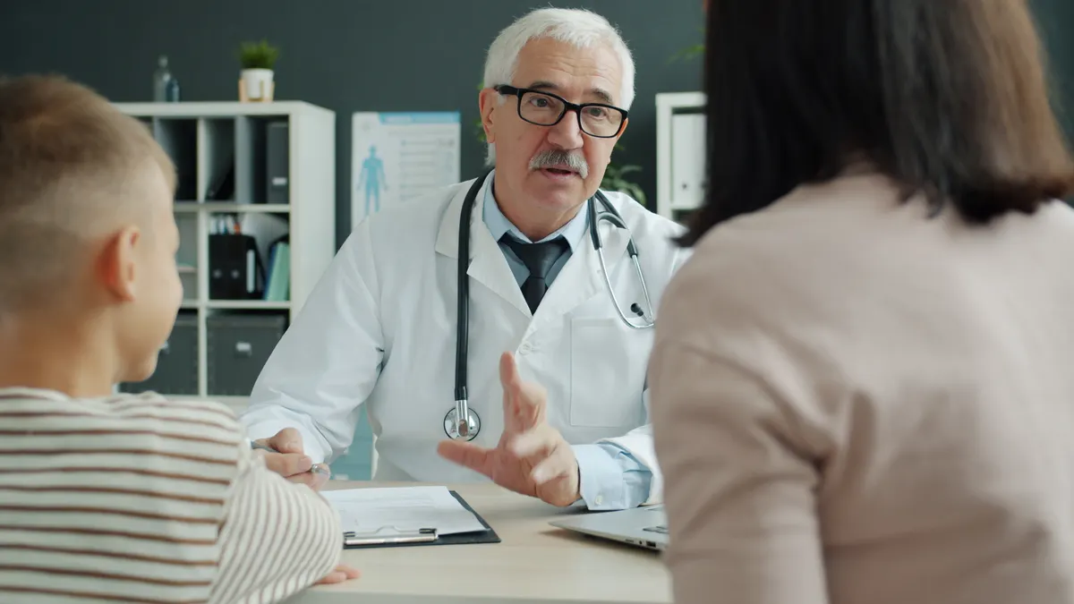 Doctor explaining something to a patient in office