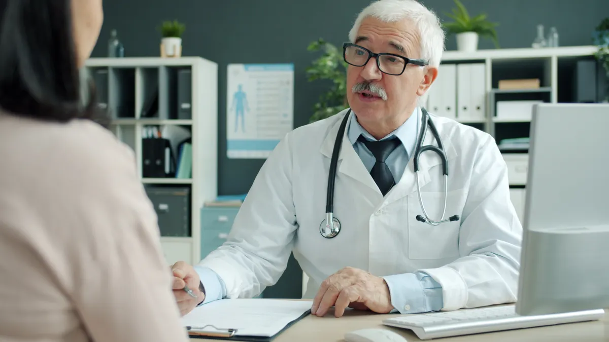 doctor speaking with a patient in clinic office